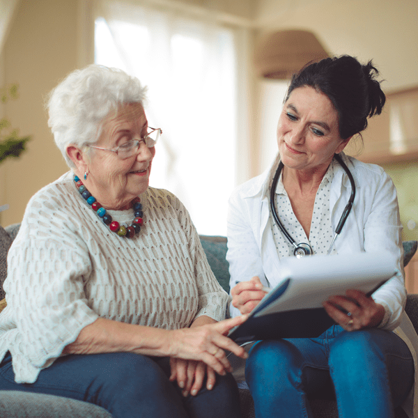 senior woman looking at results with her health care provider